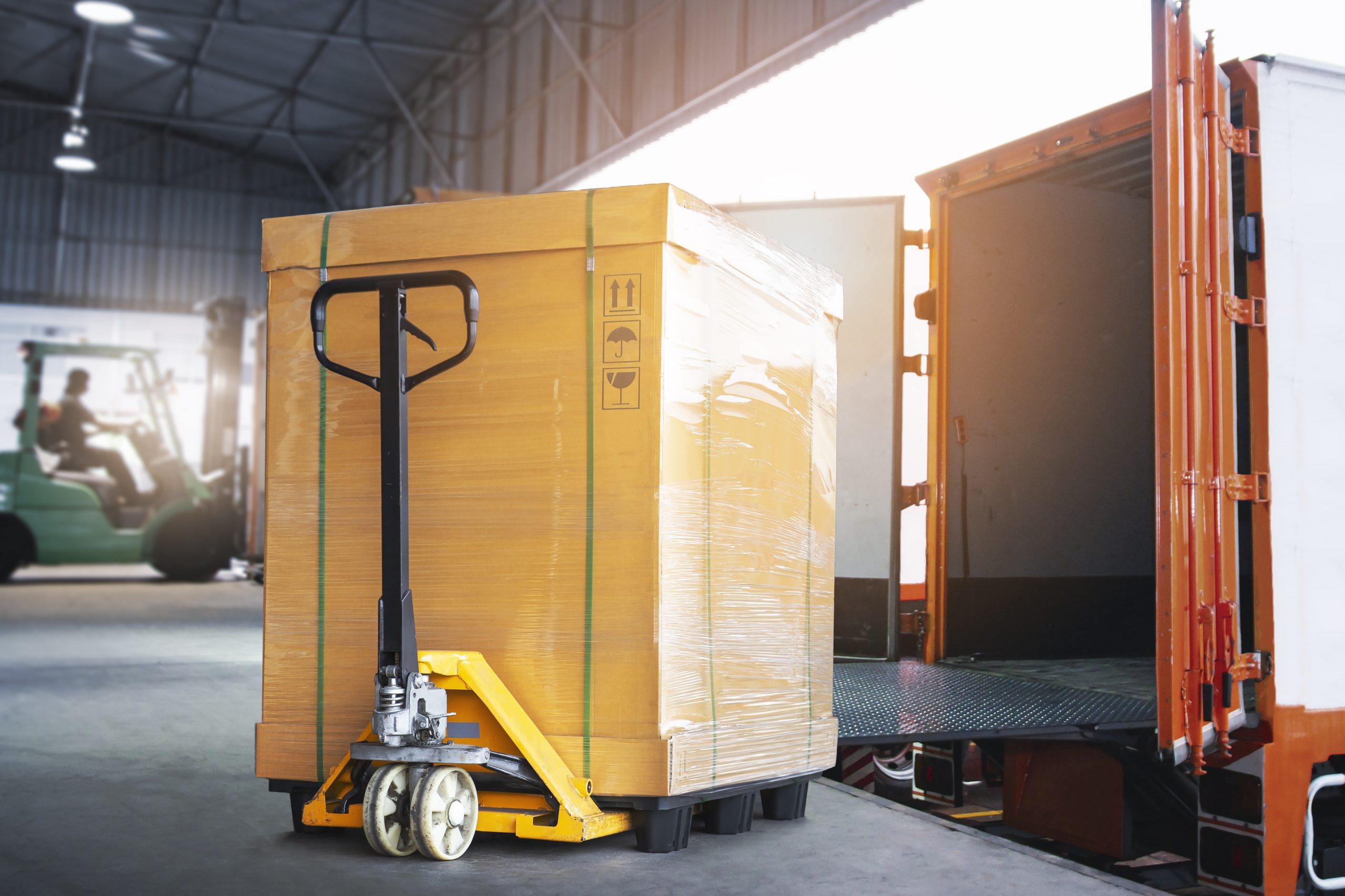 cargo-box-with-hand-pallet-truck-is-loading-into-container-shipment-delivery-warehouse-logistics